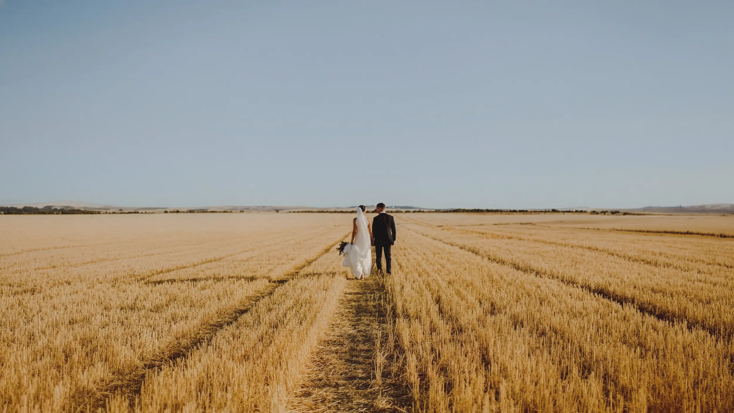 Couple walking through wheat fields in Spain